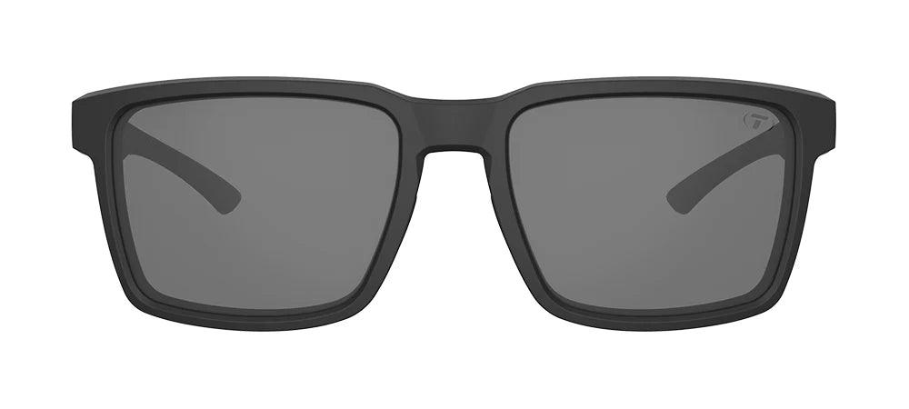 The Tifosi Sylo Sunglasses featuring a matte Blackout frame with Smoke lenses, highlighting the classic full-rim rectangular shape and lifestyle design.