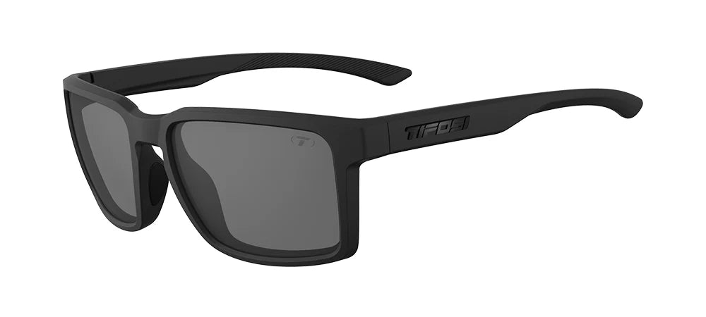 The Tifosi Sylo Sunglasses featuring a matte Blackout frame with Smoke lenses, highlighting the lightweight rectangular shape and stealthy athletic design.